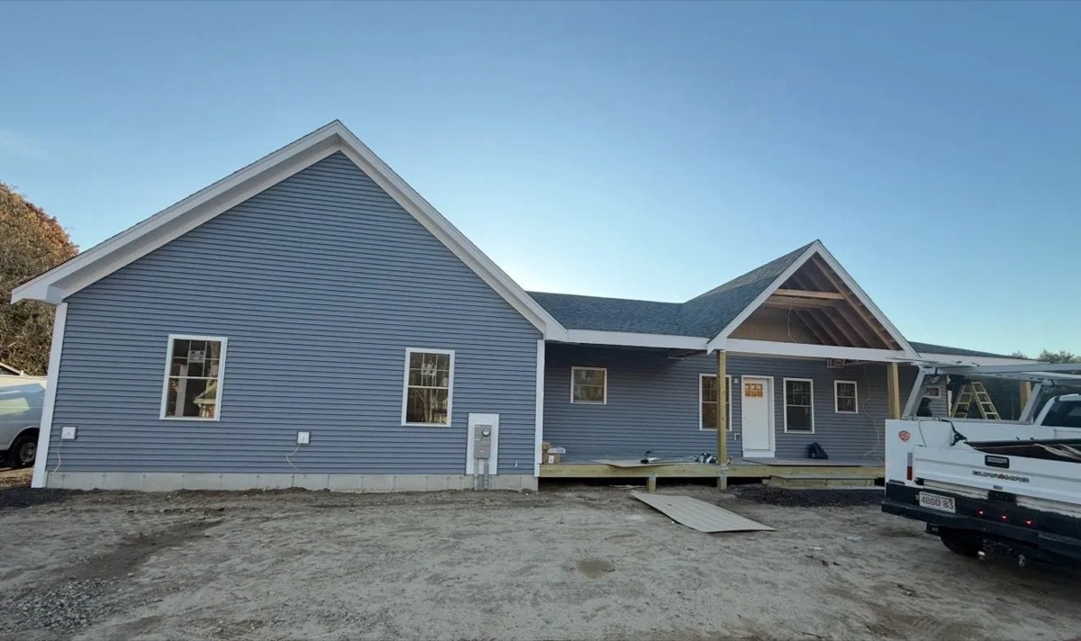 Completed single-story modular home with blue clapboard siding and gable accents — South Shore MA, near completion